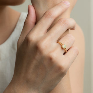 Opal on gold ring Ohana worn on hand model