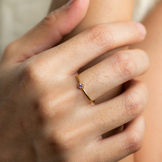 Maile Amethyst on gold ring worn on hand model