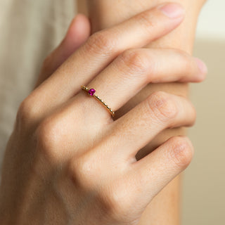 Levia Ruby on gold ring worn on hand model