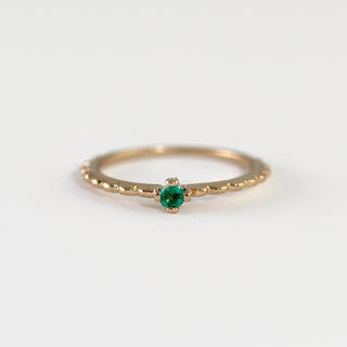 Emery Emerald on gold ring worn by hand model